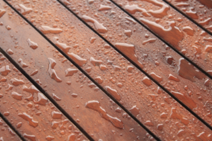 water beading up on a wooden deck because it was sealed with DuraSeal