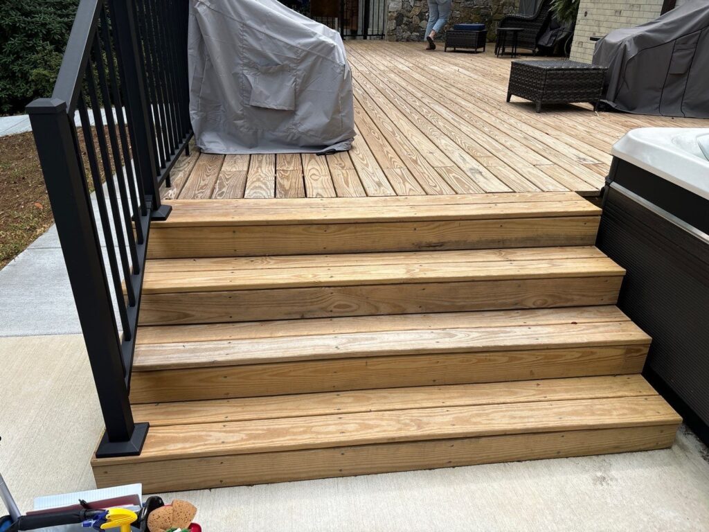 Deck sealing service team from DuraSeal Inc working on a wooden deck in Apex, NC.